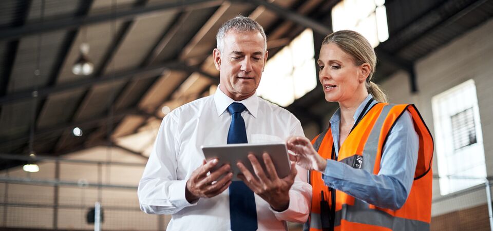 COLOUR-IMAGE_two-colleagues-speaking-over-a-tablet_apr26
