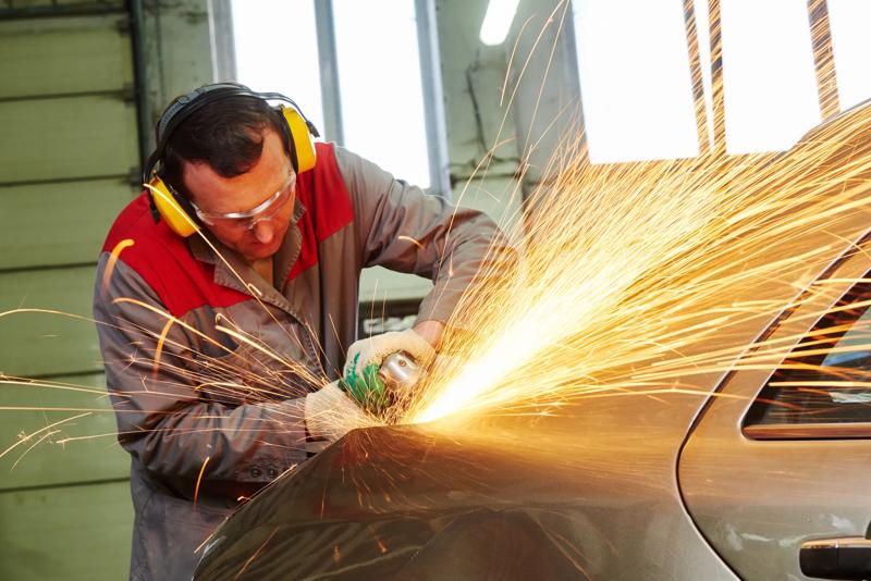 COLOUR-IMAGE_automotive-male-mechanic-using-angle-grinder-on-car-body_feb26