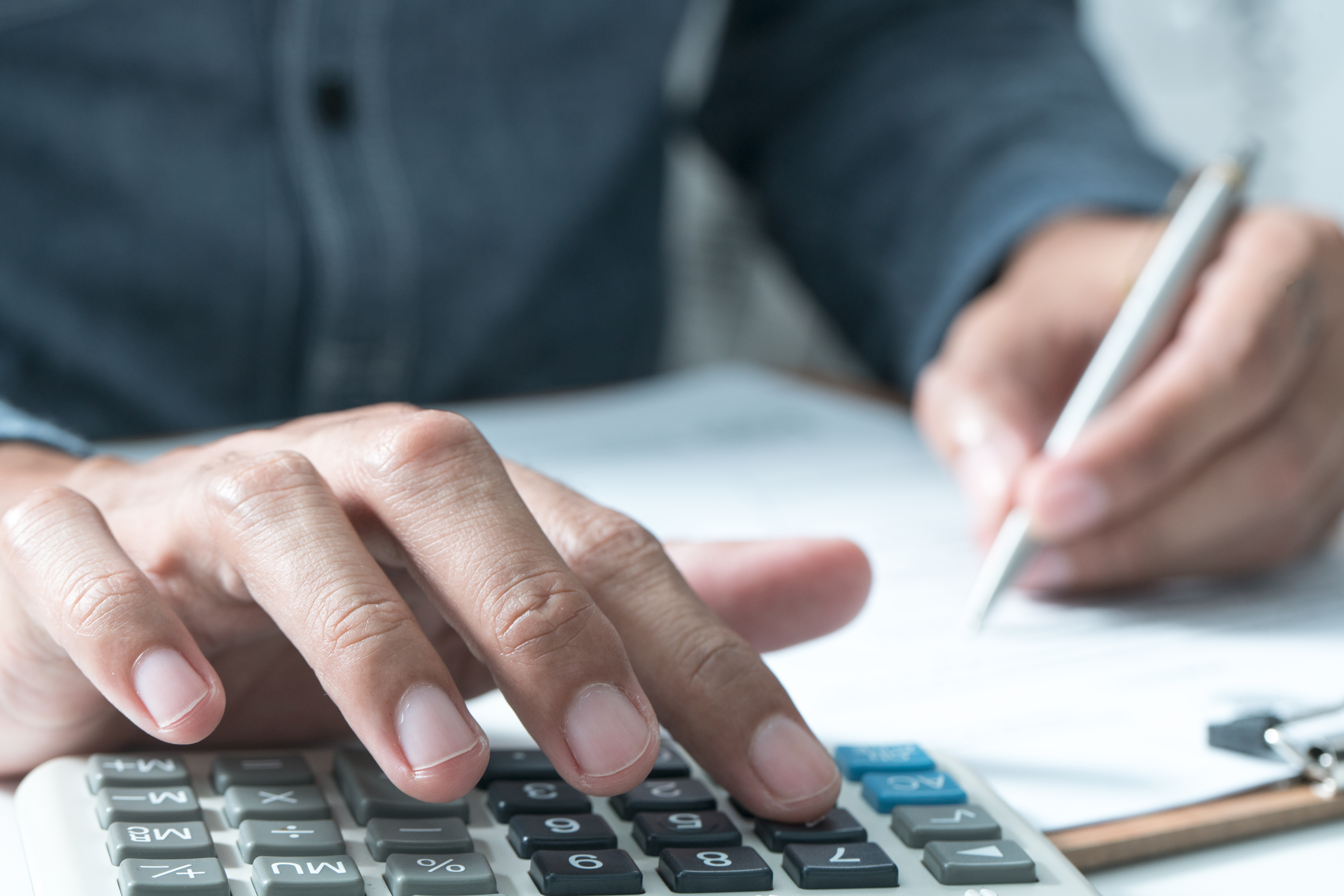 COLOUR-IMAGE_man-typing-on-calculator_feb26.jpg