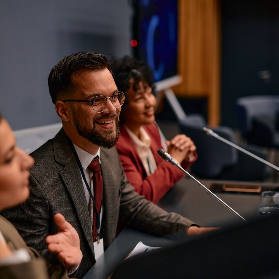 COLOUR-IMAGE_three-people-speaking-at-a-panel_feb26