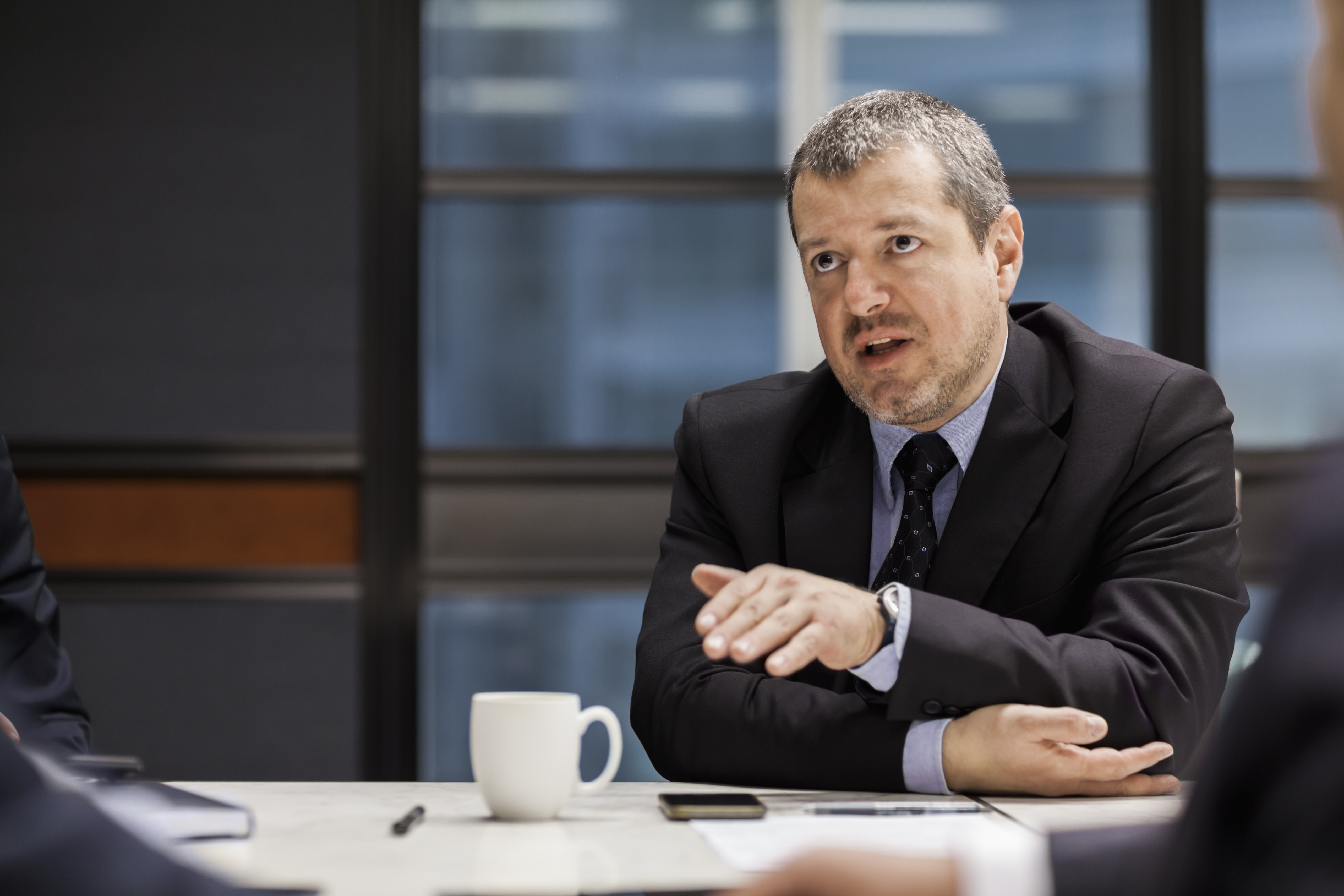 COLOUR-IMAGE_man-talking-in-meeting_feb26