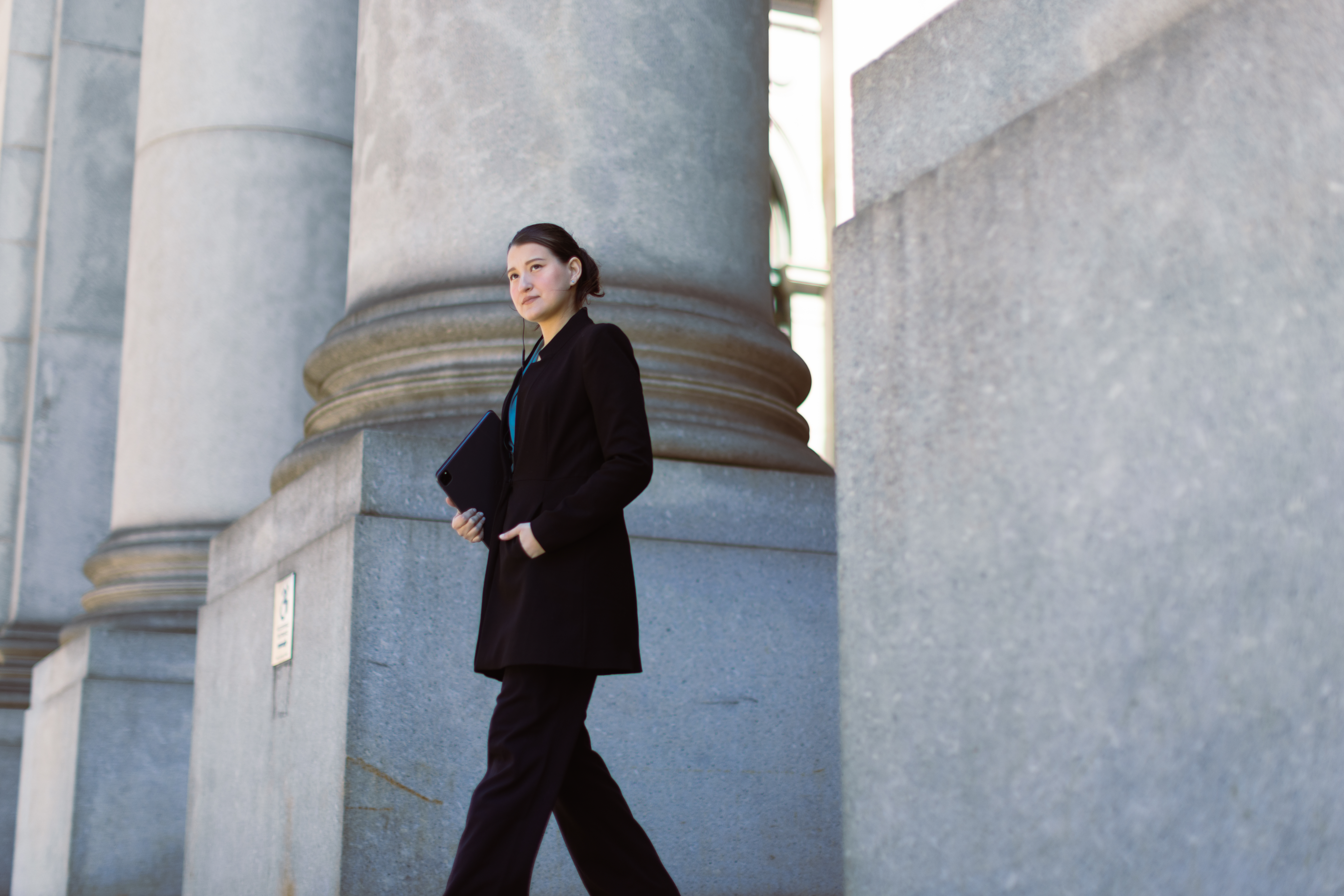 COLOUR-IMAGE_woman-walking-out-of-government-building_feb26