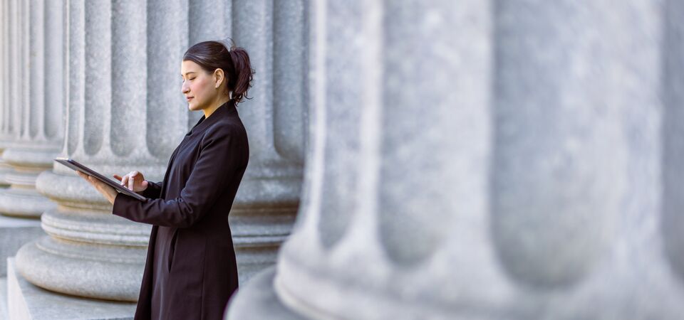 COLOUR-IMAGE_woman-standing-outside-government-building_feb26